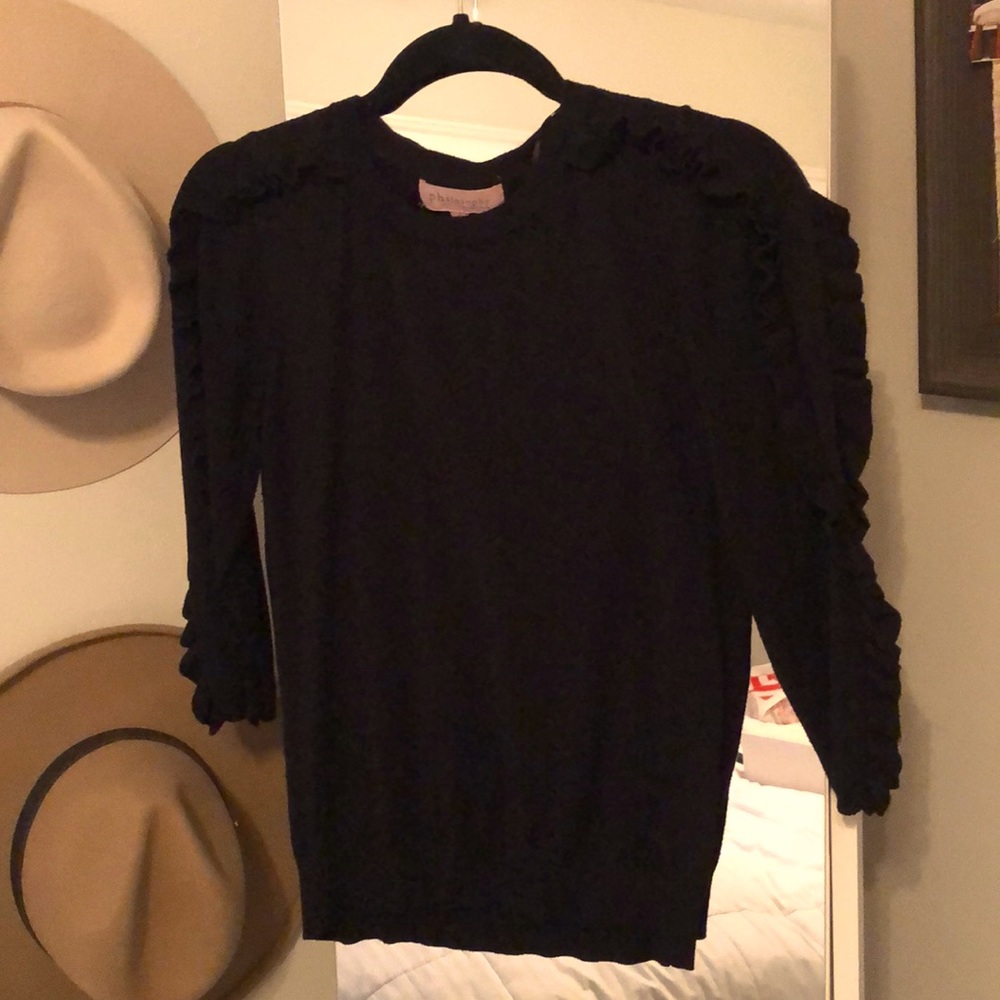 Woman’s black ruffled sweater